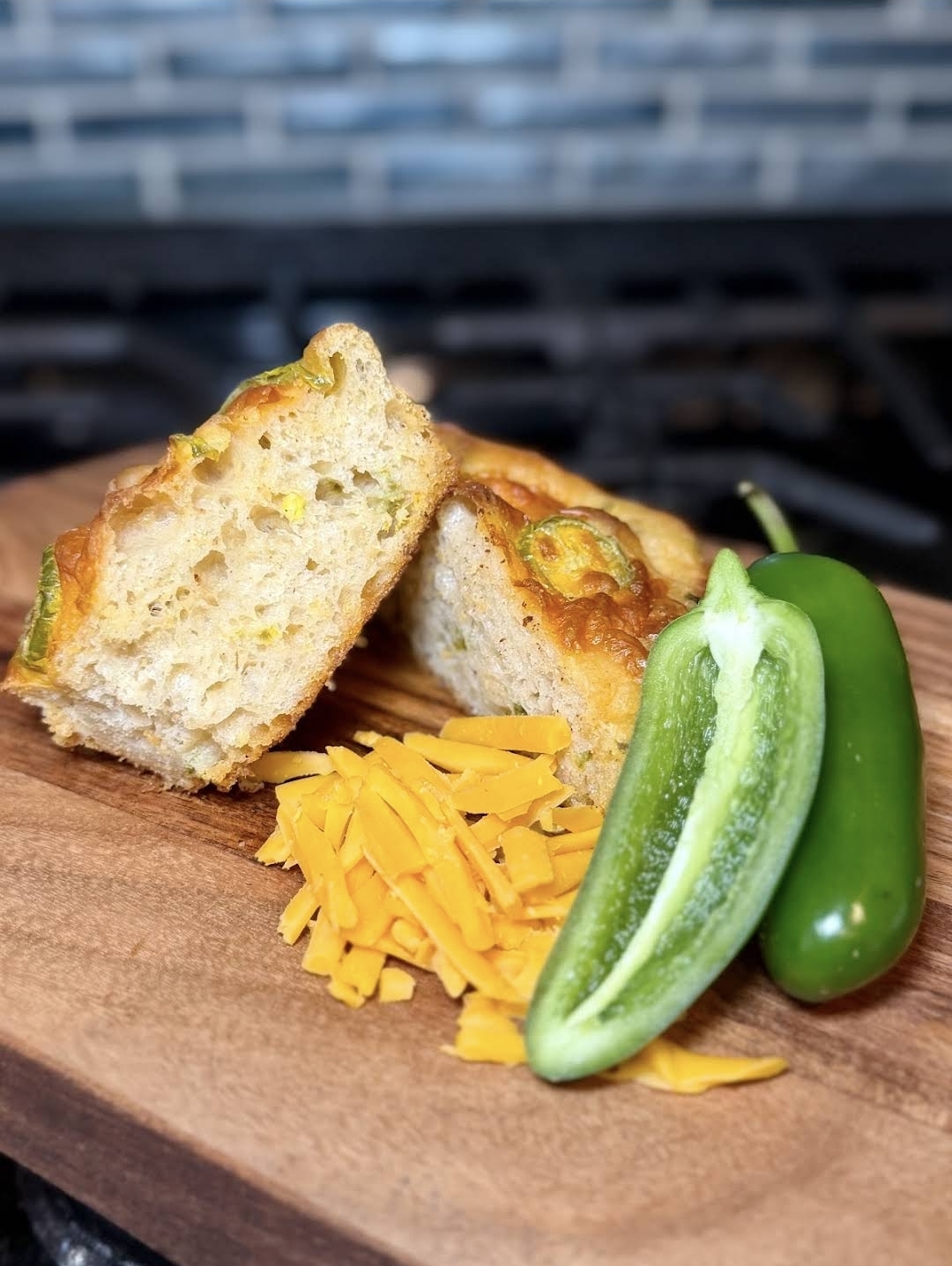 Jalapeño cheddar sourdough sliced on a wooden board